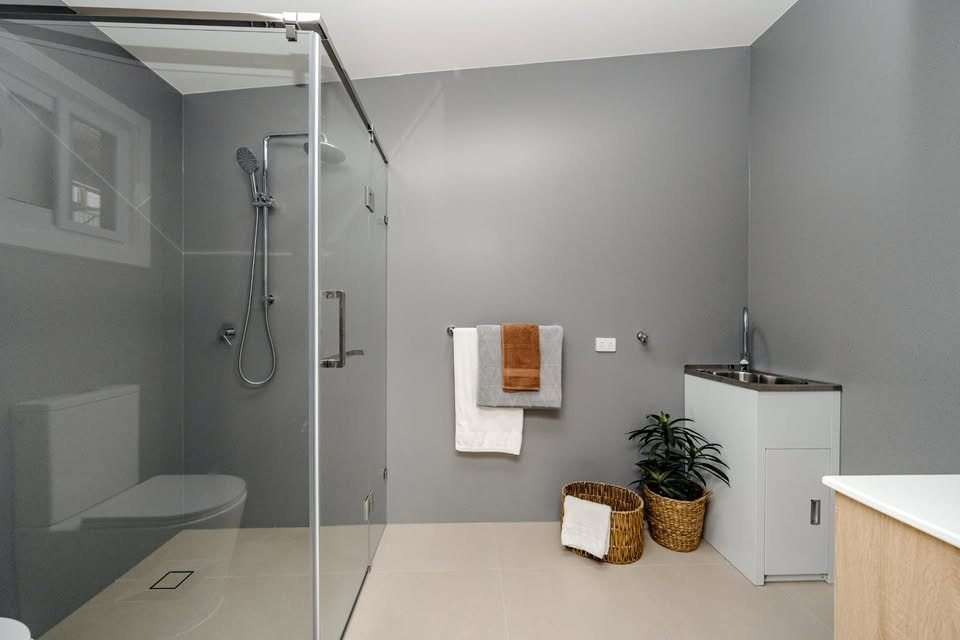 Bathroom with walk-in shower and laundry tub