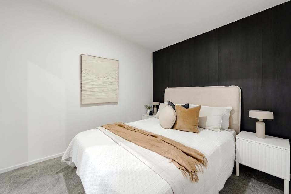 Bedroom with dark feature wall